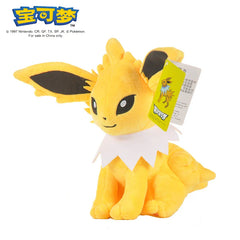 A yellow Jolteon plush toy with a white collar and a product tag attached to its ear.