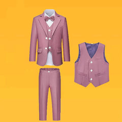 A four-piece dusty pink formal suit for boys including a jacket, vest, trousers, and a bowtie.