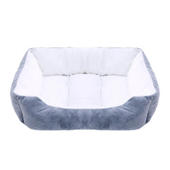 A rectangular plush pet bed with a white interior cushion and grey exterior walls.