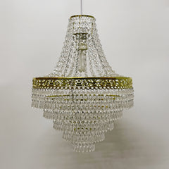 A tiered acrylic chandelier shade with clear hanging droplets and a gold-tone metal frame.