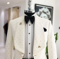A white jacquard tuxedo blazer with bead embellishments, wide lapels, and a black bow tie.