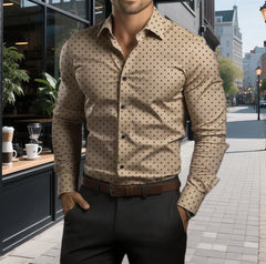 A man wears a tan long-sleeve button-down shirt with a black polka dot print.