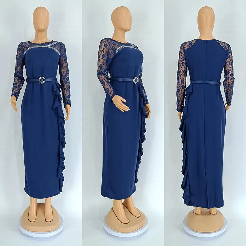 A navy blue long-sleeve maxi dress with lace sleeves, a belted waist, and a ruffled side detail.