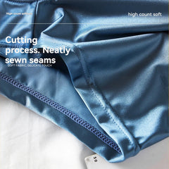 A close-up view of blue ice silk boxer shorts showing the smooth fabric and neat stitching.