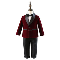 A formal boys suit featuring a burgundy velvet blazer with black lapels, a white shirt, a black bow tie, and black trousers.