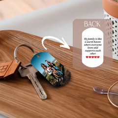 A personalized metal keychain featuring a family photo on one side and a quote on the back.