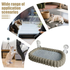 A plush, rectangular cat bed with suction cups for mounting on a window.