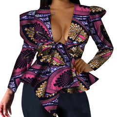 A long-sleeve peplum top with a deep V-neck and a vibrant pink and purple African print pattern.