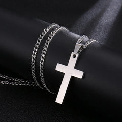 A silver-toned stainless steel cross pendant hangs from a matching link chain.