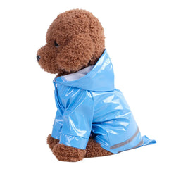 A brown plush toy dog wearing a shiny blue waterproof hooded raincoat.