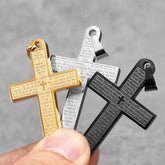 Three stainless steel cross pendants in gold, silver, and black, each engraved with the Lord's Prayer.