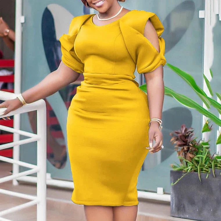 A woman wears a mustard yellow, mid-calf sheath dress with an O-neck and cold-shoulder sleeves.