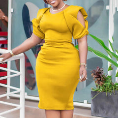 A woman wears a mustard yellow, mid-calf sheath dress with an O-neck and cold-shoulder sleeves.