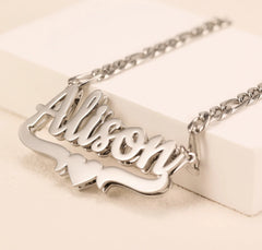A silver-toned stainless steel nameplate necklace featuring the name Alison in a 3D script font.