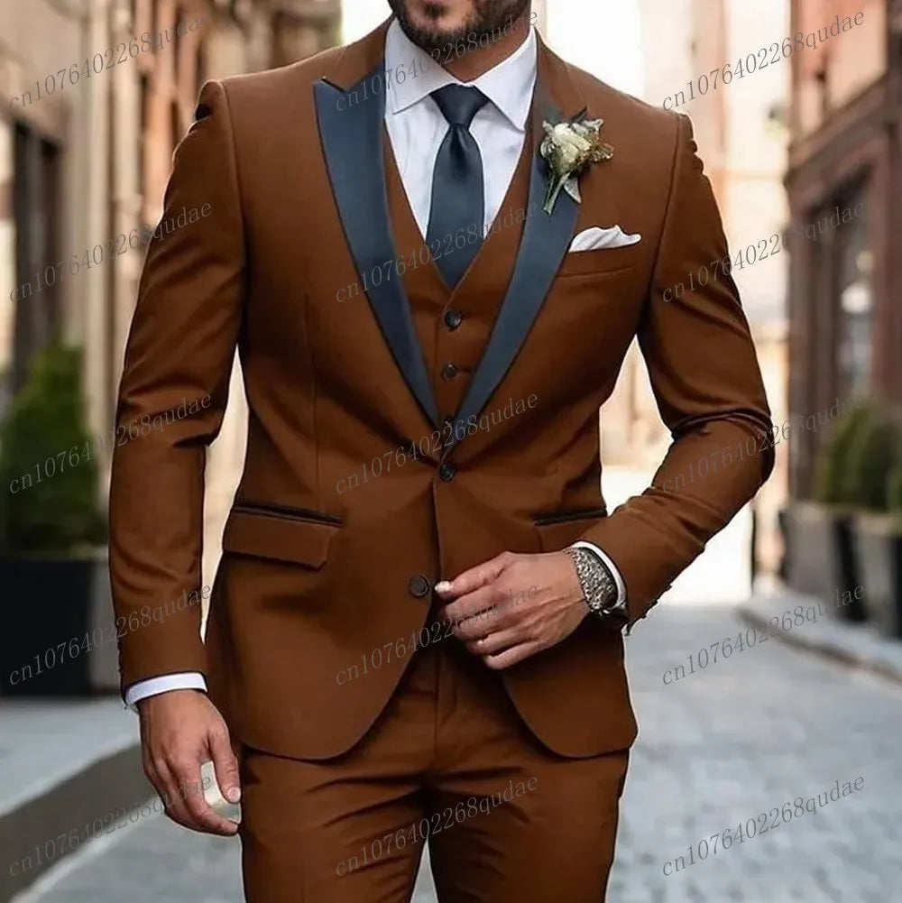 A man wears a brown three-piece suit with a black shawl collar, white shirt, and black tie.