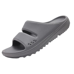 A pair of grey, thick-soled EVA slide sandals with a double-strap design and textured footbed.