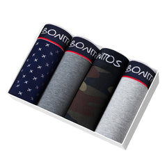 A set of four men's cotton boxer shorts in various patterns and colors inside a white box.