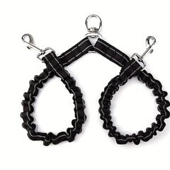 A black nylon double dog leash coupler with shock-absorbing bungee sections and reflective trim.