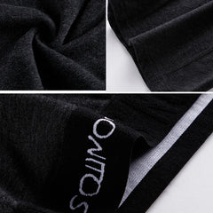 Close-up of dark grey men's boxer shorts featuring a branded elastic waistband.
