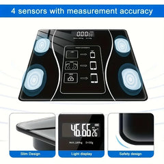 A black digital body scale with four sensors and a backlit LED display screen.