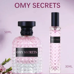 Two glass perfume bottles labeled OMY SECRETS in 50ml and 30ml sizes against a light purple background.