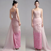 A model wears a floor-length pink satin evening gown with a pleated waist and floral embroidery.