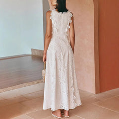 A woman wears a white sleeveless A-line midi dress featuring intricate lace embroidery.
