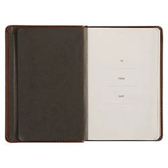 An open brown leather devotional journal with a blank dedication page for to, from, and date.
