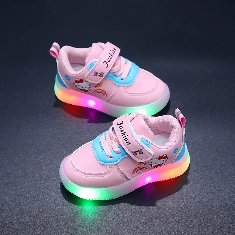 A pair of pink Hello Kitty sneakers for girls with light-up soles and hook-and-loop closures.