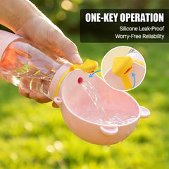 A hand holds a pink portable pet water bottle with a built-in bowl and a leak-proof silicone seal.