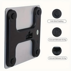 A silver and black electronic scale shown from the bottom with callouts for its features.
