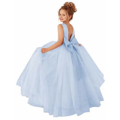A young girl wears a sleeveless, floor-length light blue ball gown with a large bow on the back.