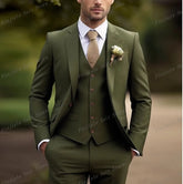 A man wears an army green three-piece suit with a white shirt and a textured tan tie.