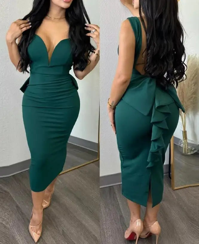 A woman wears a dark green, sleeveless, mid-calf sheath dress with a plunging sweetheart neckline.