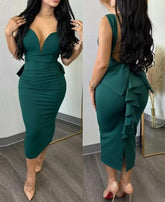 A woman wears a dark green, sleeveless, mid-calf sheath dress with a plunging sweetheart neckline.