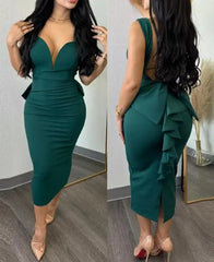 A woman wears a dark green, sleeveless, mid-calf sheath dress with a plunging sweetheart neckline.