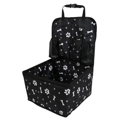 A black portable dog car booster seat with a white paw print and bone pattern and storage pockets.