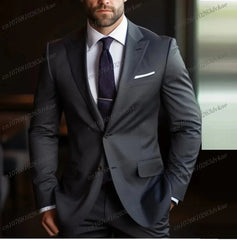 A man wearing a dark brown two-piece formal suit with a white shirt and a dark tie.