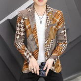 A man wears a slim-fit, single-breasted blazer featuring a patchwork of brown and tan patterns.