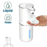 A white automatic soap dispenser with a hand receiving foam and a USB charging cable.