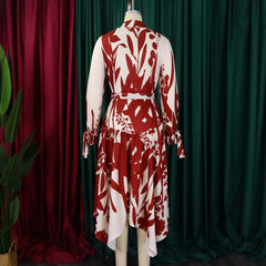 A red and white printed midi dress with a turn-down collar, long sleeves, and asymmetric hem.