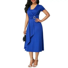 A woman wears a royal blue short-sleeve V-neck midi dress with a decorative waist buckle.