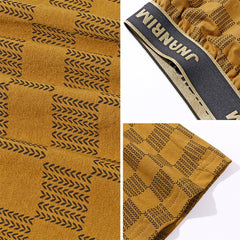 Mustard yellow cotton boxer shorts featuring a black chevron plaid pattern and a branded waistband.