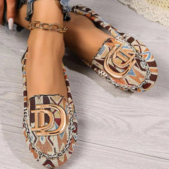 Women's patterned fabric loafers featuring a gold-tone D-shaped metal ornament on the vamp.