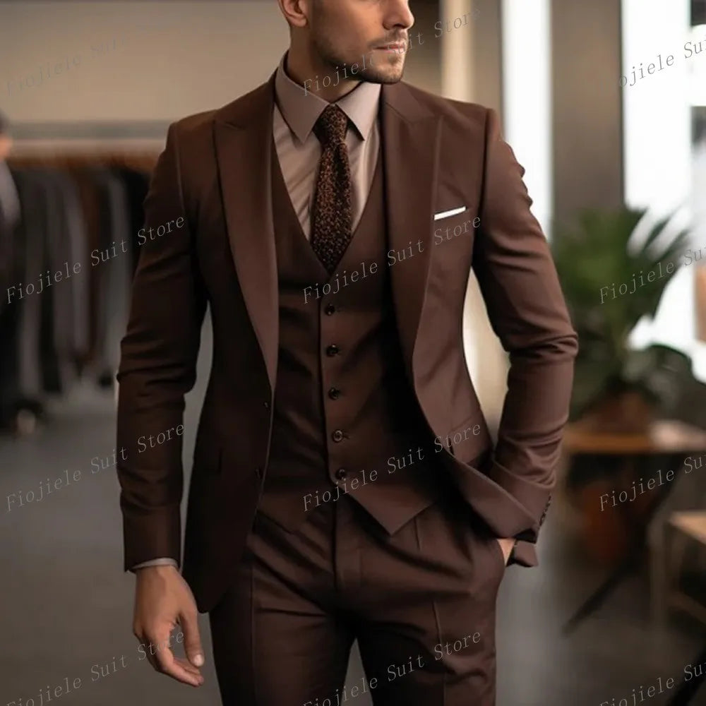 A man wears a dark brown three-piece suit with a matching vest and a patterned tie.