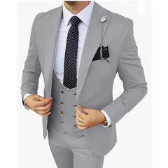 A man wears a light gray three-piece slim-fit suit with a white shirt and a black polka-dot tie.