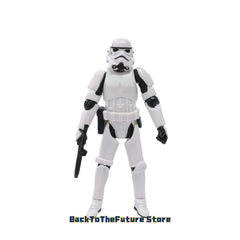 A 10cm Hasbro Star Wars Stormtrooper action figure holding a small black blaster.
