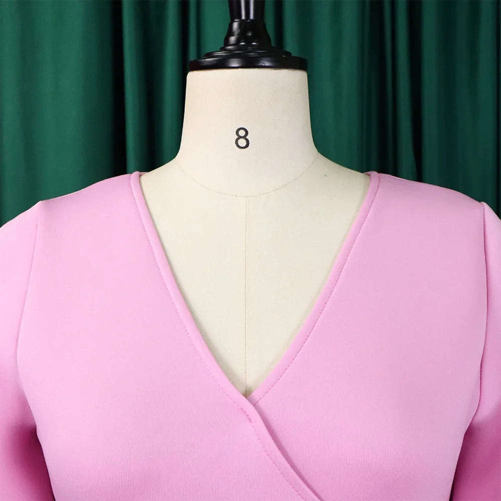 A close-up of a pink V-neck dress on a mannequin.