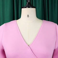 A close-up of a pink V-neck dress on a mannequin.