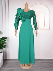 A floor-length emerald green dress with sequined long sleeves, a V-neck, and floral accents.
